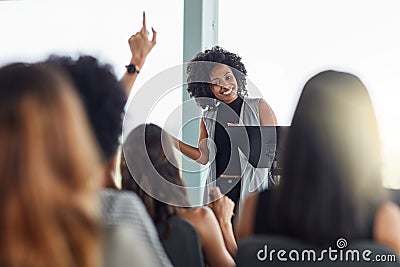 I hope that answers your question. Cropped shot of an attractive young businesswoman speaking at a business conference. Stock Photo