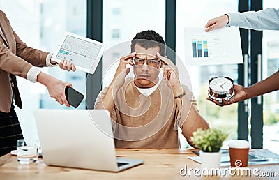 I just need a break...a young businessman looking stressed out in a demanding office environment. Stock Photo