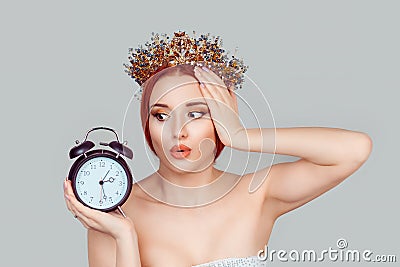 I am late. Portrait of young surprised beauty queen woman looking at alarm clock frustrated of being late in rush pretty woman Stock Photo