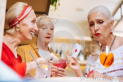 Unhappy aged woman loosing the game Stock Photo