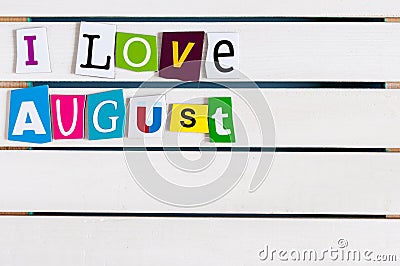 I Love August written with color magazine letter clippings on wooden board. Summer vacation concept, empty space for Stock Photo