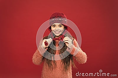 I love this hat so mush. Happy girl wear knitted hat. Little child smile in hat with earflaps and braided fringe. Warm Stock Photo