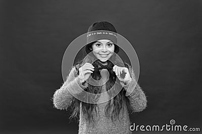I love this hat so mush. Happy girl wear knitted hat. Little child smile in hat with earflaps and braided fringe. Warm Stock Photo
