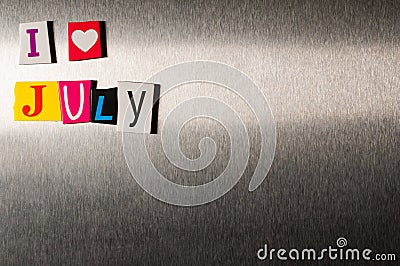 I Love July written with color magazine letter clippings on metal background. Concept of summer time and vacation. Empty Stock Photo