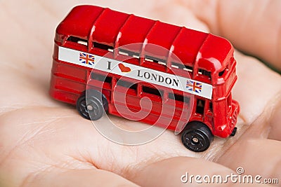 I love London message on red bus, souvenir and symbol of London City, isolated on womanâ€™s hand Stock Photo