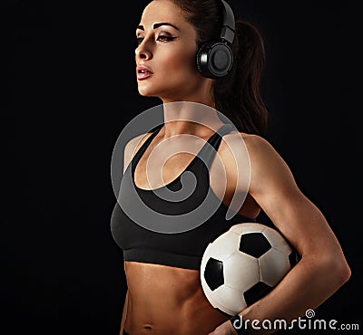 I love my body, fit, mobile, strong, flexible (look description under photo). Sport woman holding ball in headphones Stock Photo