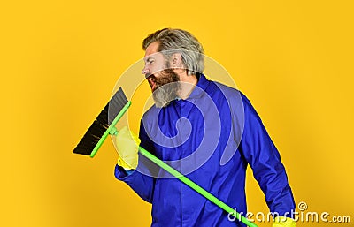 I love singing. sweeping the floor. man cleaner. bearded man cleaning with mop. Janitor in gloves. husband cleaning Stock Photo