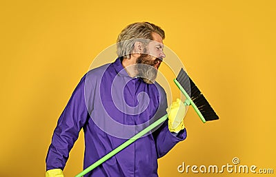 i love singing. sweeping the floor. man cleaner. bearded man cleaning with mop. Janitor in gloves. husband cleaning Stock Photo