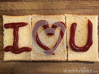 I Love U by bread on the wooden cutting board Stock Photo