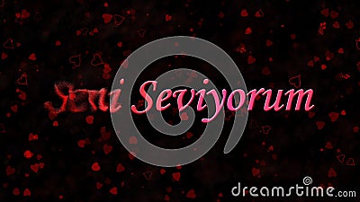 I Love You text in Turkish Seni Seviyorum turns to dust from left on dark background Stock Photo