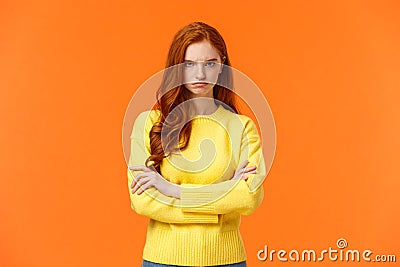 I am mad. Offended sulky cute and timid redhead curly girl, cross arms chest, sulking angry and tensed, frowning stare Stock Photo