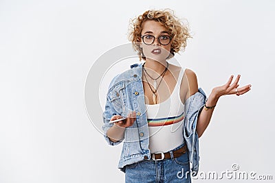 I not get it, what I did wrong. Portrait of confused and clueless girl raising hand in dismay and questioned gesture Stock Photo