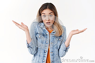 I not know. Unaware clueless silly blond asian girl shrugging hands spread sideways full confusion open mouth raise Stock Photo