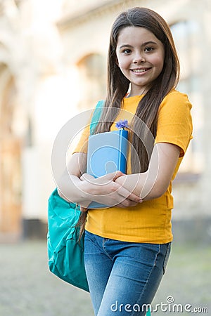 I read because it is relaxing. Happy child hold book outdoors. School library. Literacy education. Literature and Stock Photo