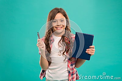 I am ready for school. Child smart kid hold pen and notepad. Girl cute happy face likes to study blue background. Child Stock Photo