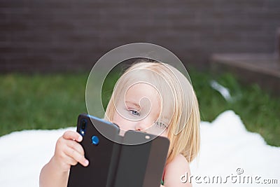 I see you. New technology for children. Small child make video call with smartphone. Small girl with mobile phone. Girl Stock Photo