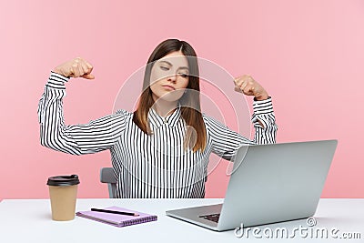 I am strong and independent. Confident business woman raising hands showing biceps talking on video call, feeling proud receiving Stock Photo