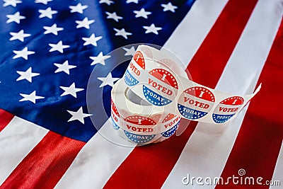 I vote today stickers roll, in US elections on American flag Editorial Stock Photo