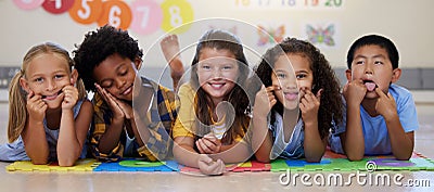 I want everyone to feel at home in my class. a group of kids laying on the floor in class. Stock Photo