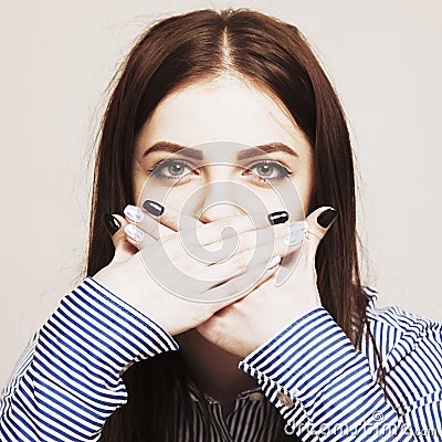 I will not tell you anything. Silence tabu secret mystery communication concept. Woman covering the mouth with her hands. Stock Photo