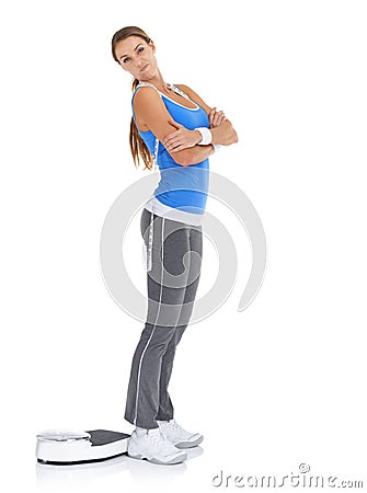 I wish Id lost more.....Young woman in sportswear looking disappointed while standing alongside a scale. Stock Photo