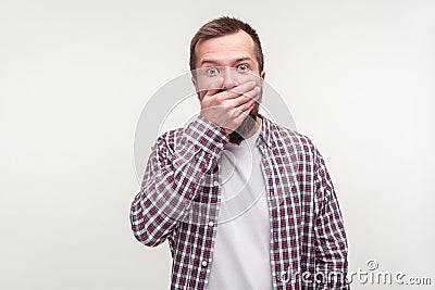 I won`t tell! Portrait of intimidated bearded man covering mouth with hand, scared to testify. white background Stock Photo