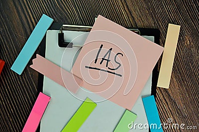 IAS write on sticky notes isolated on Wooden Table Stock Photo