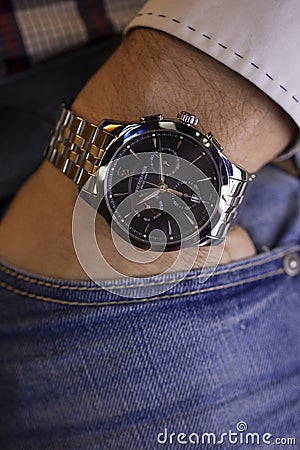 Ibach, Switzerland 31.03.2020 - Closeup fashion image of Victorinox watch on wrist of man: man`s hand in blue jeans Editorial Stock Photo