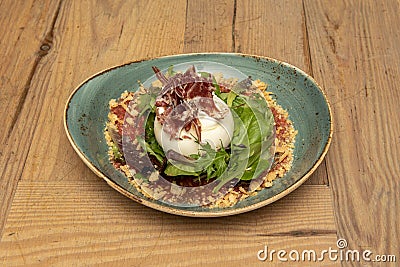 Iberian burrata salad with ball cheese, Iberian ham, crushed tomato and breadcrumbs with sprouts of lettuce mixed Stock Photo