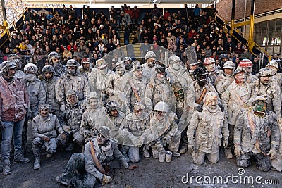 Group of people participating in traditional battle called 'Els Enfarinats' of Ibi, Spain and public in the background Editorial Stock Photo