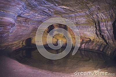 Ibitipoca national park in Brazil cave with little lighting and a small lake Stock Photo