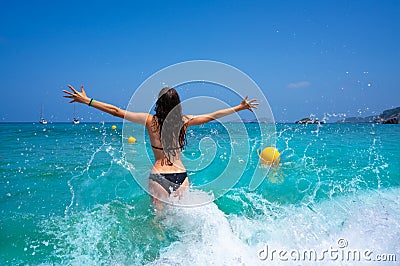 Ibiza beach girl splashing water in Balearics Stock Photo