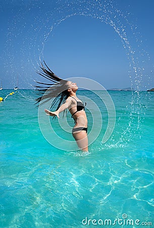 Ibiza beach girl water hair flip in Balearics Stock Photo