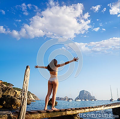 Ibiza cala d Hort girl pier sunset Es Vedra Stock Photo