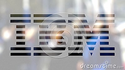 IBM logo on a glass against blurred crowd on the steet. Editorial 3D rendering Editorial Stock Photo