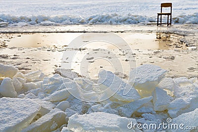 Ice blocks and chair on edge of ice-hole Stock Photo