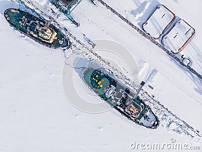 Ice bound ships froze in snow in winter, waiting for breaker, aerial top view Stock Photo