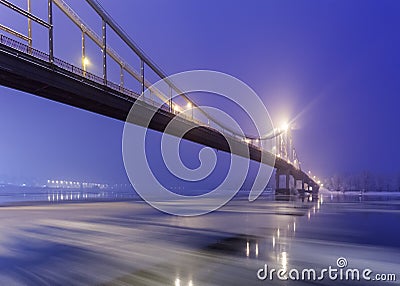 Ice is broken. Footbridge in winter city. Stock Photo