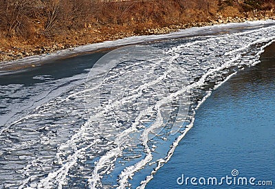 Ice Buildup On Shore Of River In Autumn Stock Photo