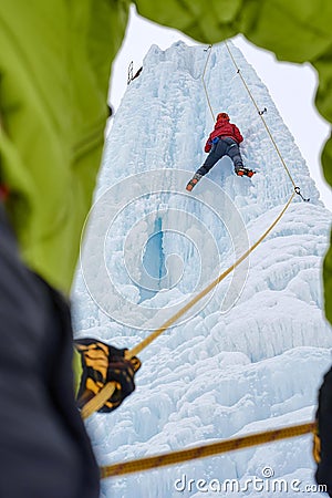 Ice climber belay with a rope and click up. hands close up Stock Photo