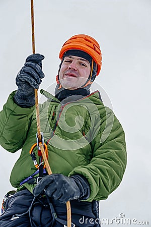 Ice climber belay with a rope and click up. hands close up Stock Photo