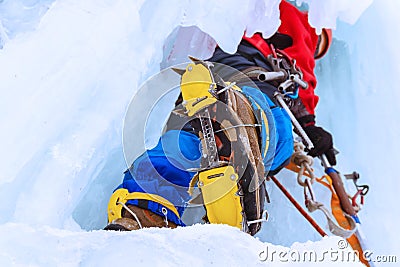 Ice climber on a vertical wall of a frozen waterfall, bottom up view Stock Photo
