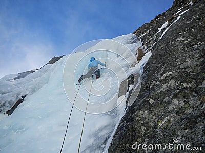 Ice climbing on a frozen icefall Stock Photo