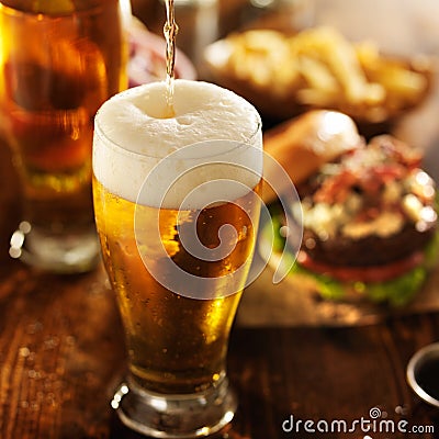 Ice cold beer pouring into glass Stock Photo