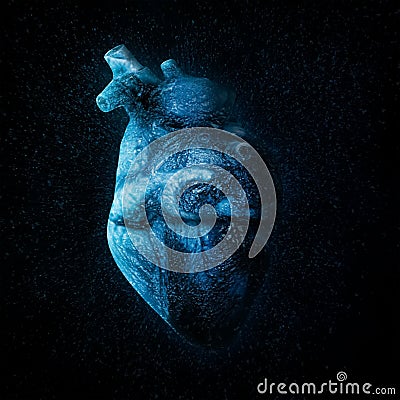 An ice cold blue heart Over black Stock Photo