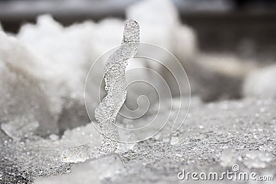 Ice column standing on snow Stock Photo