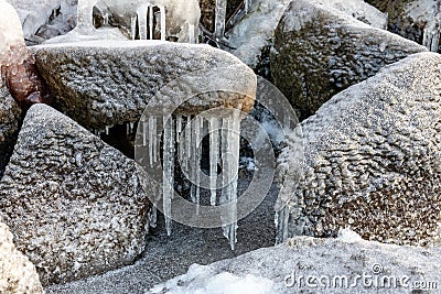 Ice-covered rocks. Frozen lakeside. Stock Photo