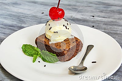 Ice cream and browny with cherry and mint Stock Photo