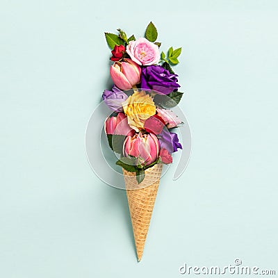 Ice cream cone with flowers and leaves. Summer minimal concept. Stock Photo