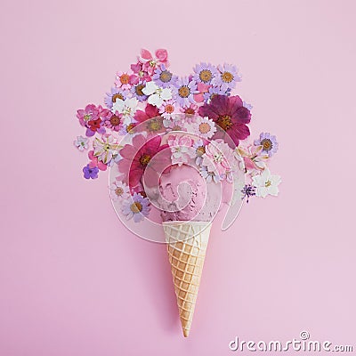 Ice cream cone with Icse cream and flowers. Spring and summer Floral style. Flat lay Stock Photo